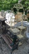 Three cream painted three tier garden stands, black painted metal candle pricket,