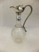 An early 20th Century cut glass claret jug, the body decorated with swag, rope and star motifs,