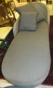 A modern grey painted wicker conservatory chaise longue with charcoal coloured cushions,