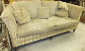 A modern two seat sofa by Greensmith's in beige upholstery