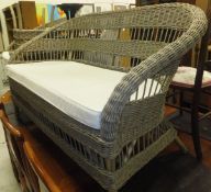 A modern caned four piece conservatory suite, comprising two seater settee, armchair,