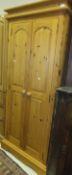 A modern pitch pine two door wardrobe