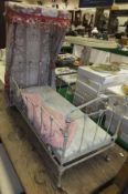 A circa 1900 doll's crib in the form of a half tester bed,