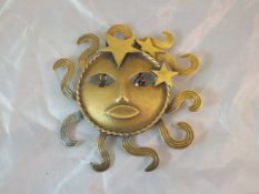 A Joseff of Hollywood gilt metal sun brooch with crystal set eye