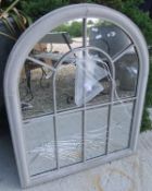 A small arched outdoor mirror *