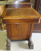 A Victorian walnut and cross-banded Davenport desk, the top with stationery compartment over a