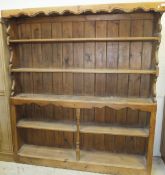 A waxed pine dresser of five open shelves with boarded backs