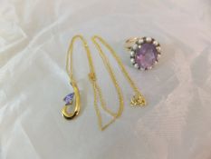 An amethyst and seed pearl set 9 carat gold dress ring and a 9 carat gold and tanzanite pendant and