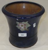 A Royal Doulton jardinier, the blue ground with floral spray relief decoration and ribbed base,