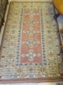 A Caucasian rug, the five central diamond shaped medallions in shades of cream,