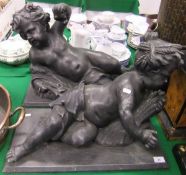 A pair of cold cast ornaments formed as reclining putti  CONDITION REPORTS Approx 57cm x 29cm x 40cm