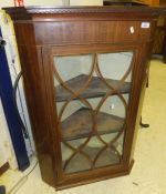 A mahogany wall hanging corner cabinet with astragal glazed doors and inlaid decoration