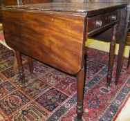 A mahogany Pembroke table on turned legs to brass castors