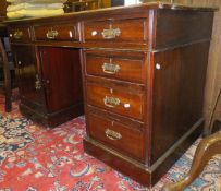 A mahogany pedestal desk with black leather inset top over six drawers and cupboard door with brass