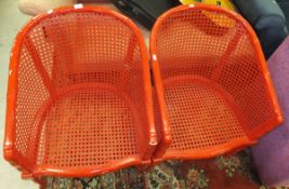 A pair of red painted tub chairs with caned seat and back and faux bamboo design frames