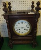 A circa 1900 oak cased mantel clock with pilaster and ball finial decoration,