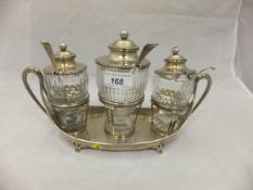 A George III silver cruet stand of boat shaped form, raised on four pad feet,