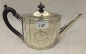 A George III silver teapot of oval form with engraved cartouche suspended on a bow,