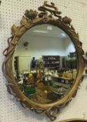 An Art Nouveau style lily decorated giltwood and gesso framed wall mirror