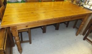 A modern pine kitchen table on turned and ringed legs