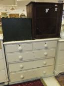 A white painted chest of two short and three long drawers on plinth base,