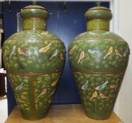 A pair of Persian style painted metal urns of large proportions decorated with birds amongst