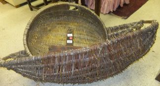 A large circular wicker basket, a large oval wicker trug,