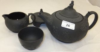 A Wedgwood black basalt teapot with matching jug and sugar bowl,