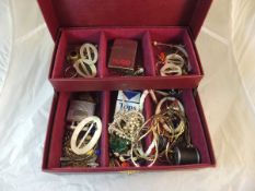 A jewellery box containing assorted costume jewellery, various necklaces, mother of pearl buckles,