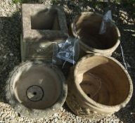 Two large composite garden planters and a composite urn on base