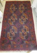 A Bokhara rug, the six central elephant foot medallions in aubergine, mustard, red and cream,