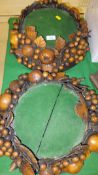A pair of carved treen ware fruit decorated stands with green baize tops