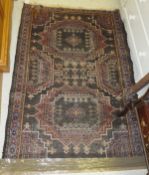 A Caucasian rug, the two central medallions in shades of terracotta, cream, blue and madder,