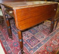 A 19th Century mahogany Pembroke table on turned supports to brown china castors