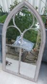 A tall arched outdoor mirror *