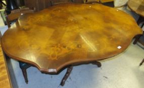 A modern mahogany Italian style dining table, the shaped top with floral decoration,