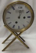 A brass bodied mantel clock with eight day movement and blue Roman numerals to the enamelled dial,