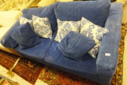 A modern two seat sofa bed upholstered in blue chenille type fabric