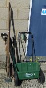 A Scotts Evergreen Seed Spreader and a small quantity of long handled garden tools