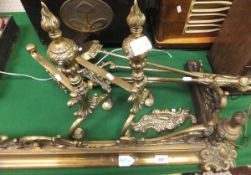 A brass fender of rococo design,