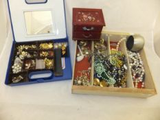 A box containing assorted costume jewellery to include various beaded necklaces, assorted earrings,