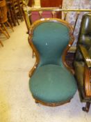 A Victorian carved walnut framed spoon back salon chair on cabriole front legs to castors