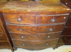 An early Victorian mahogany bow fronted chest of two short and three long graduated drawers on