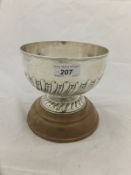 A Victorian silver rose bowl with wrythen embossed decoration, raised on a circular foot,