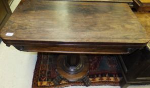 An early Victorian rosewood card table, the rounded rectangular fold-over top on a faceted