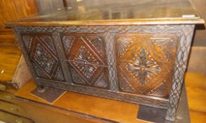An oak three panelled front blanket chest on stile feet