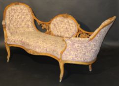 A Victorian carved walnut framed and buttoned upholstered double spoon back sofa in the Louis XV