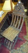 A Middle Eastern carved hardwood and inlaid folding chair