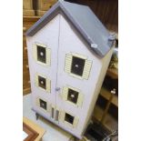 A vintage painted doll's house, the two doors opening to reveal a four storey interior with
