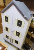 A vintage painted doll's house, the two doors opening to reveal a four storey interior with